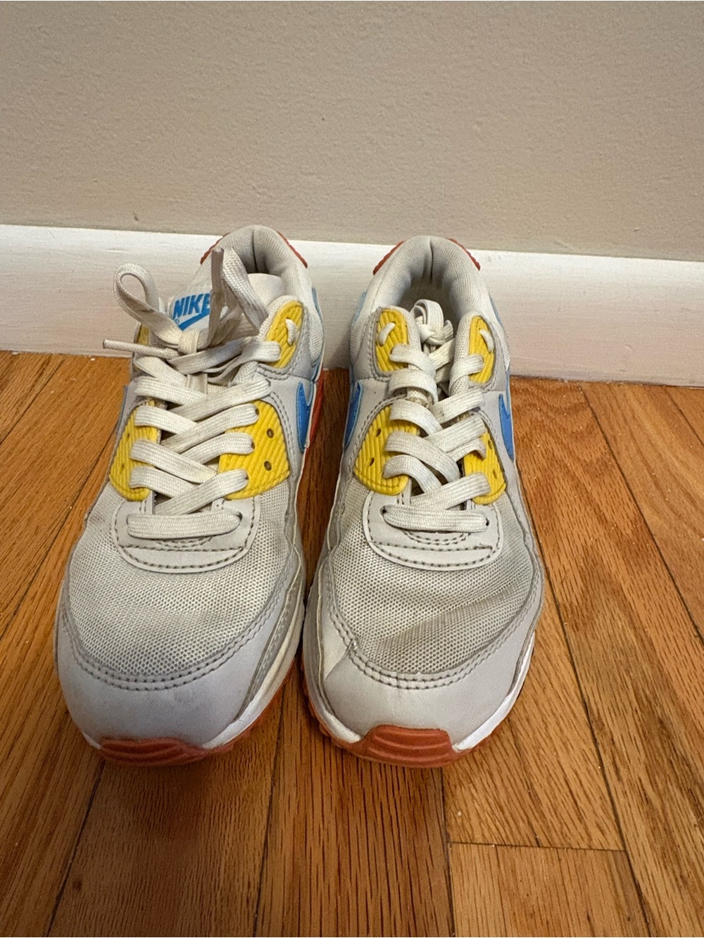 Nike Kids White Sneakers with Blue and Yellow Accents